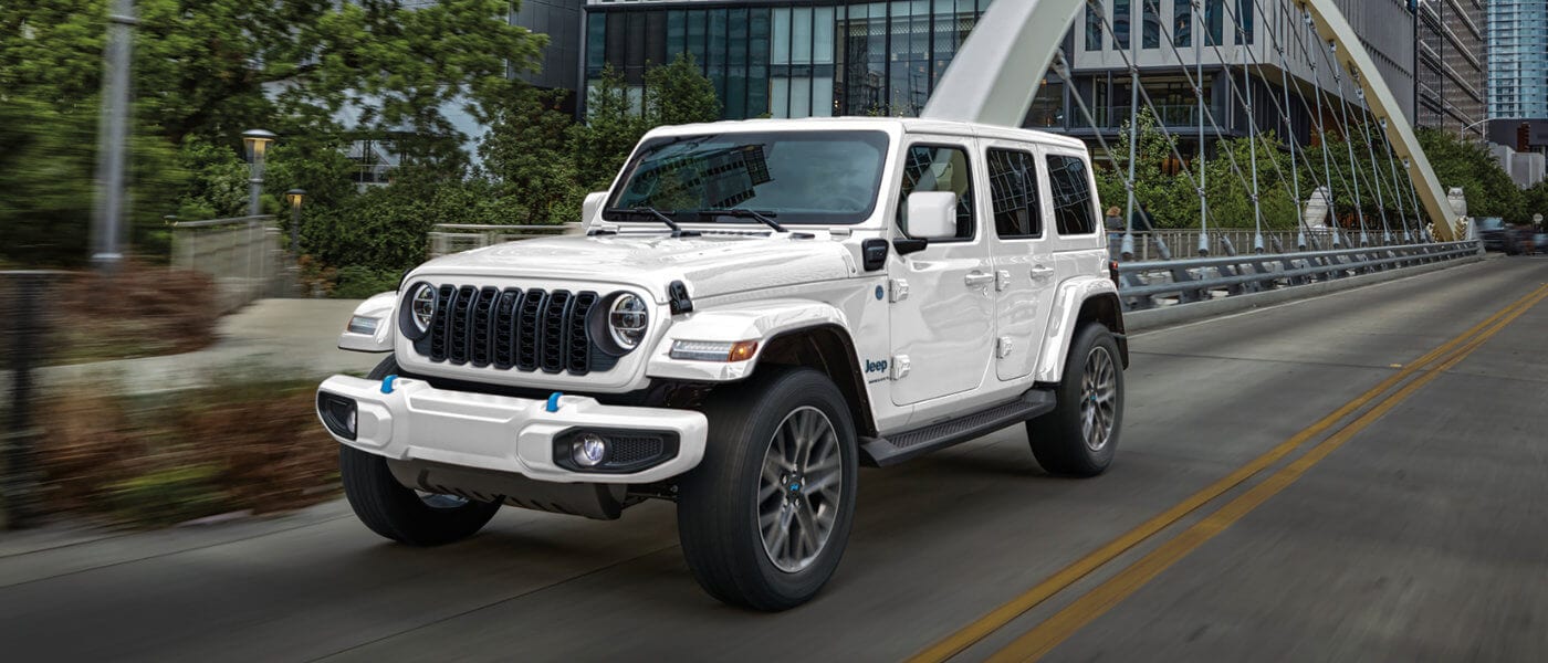 2025 Jeep Wrangler 4xe driving on a bridge