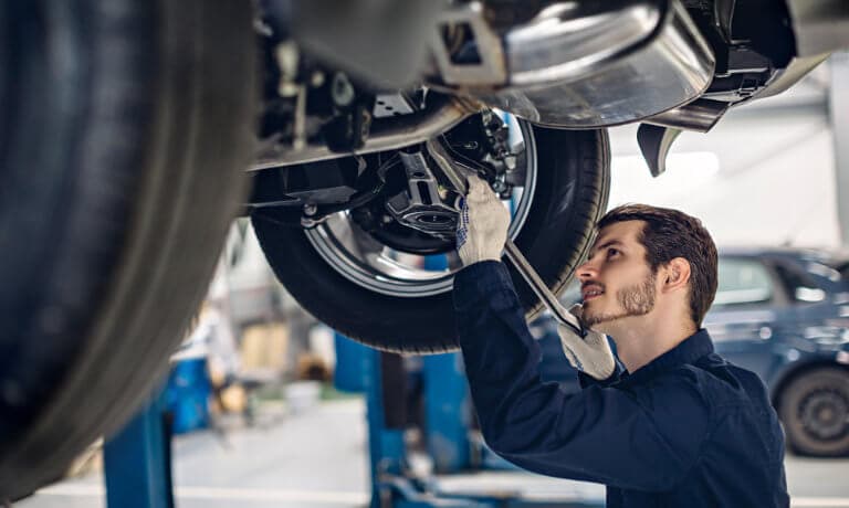 Technician working under car