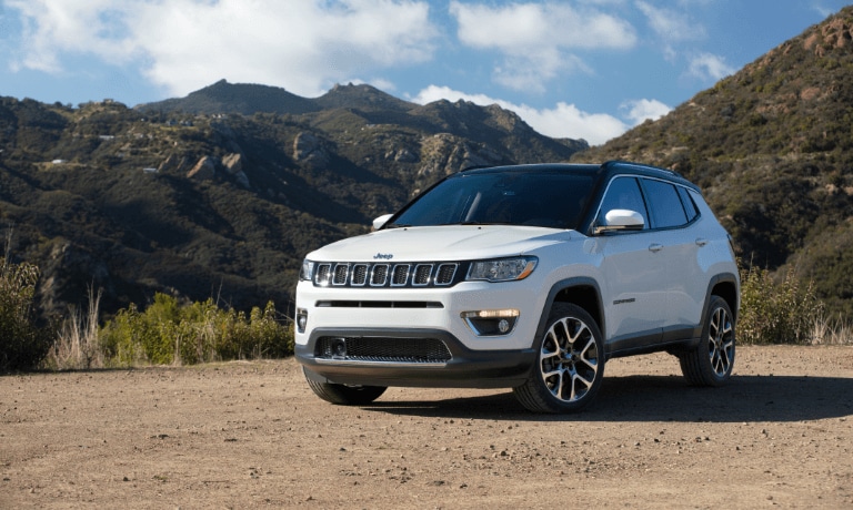 2021 Jeep Compass parked by a mountain