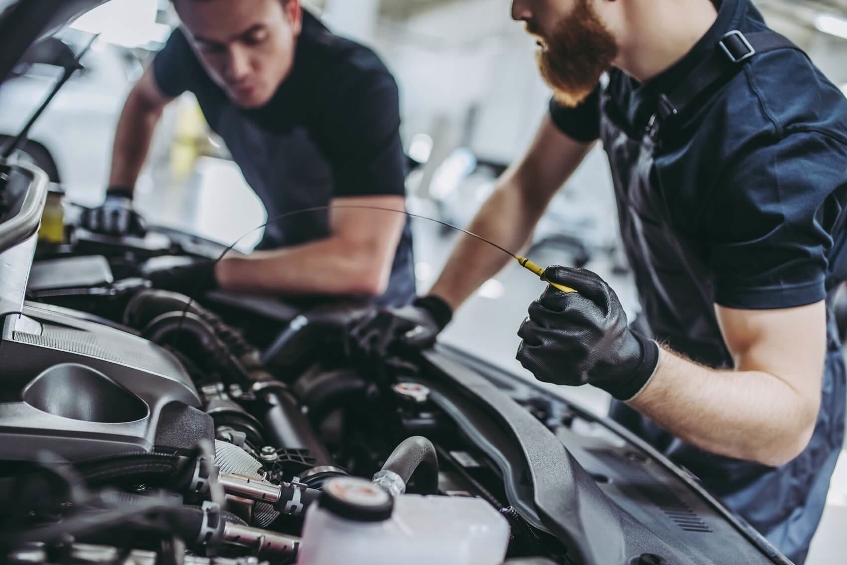 two men fixing vehicle
