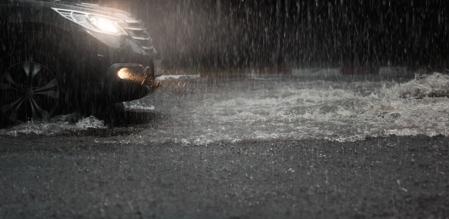 Car with headlights safely driving during as storm