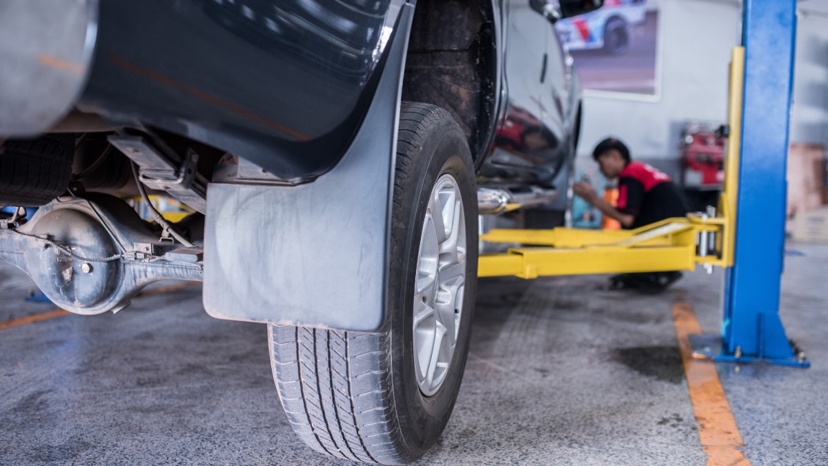 A car's back wheel in a vehicle service center