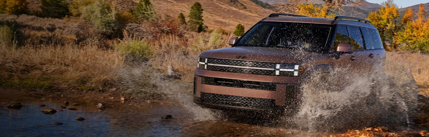 The 2024 Hyundai Santa Fe driving through a creek