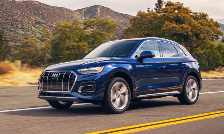 2022 Audi Q5 exterior in blue driving near mountains