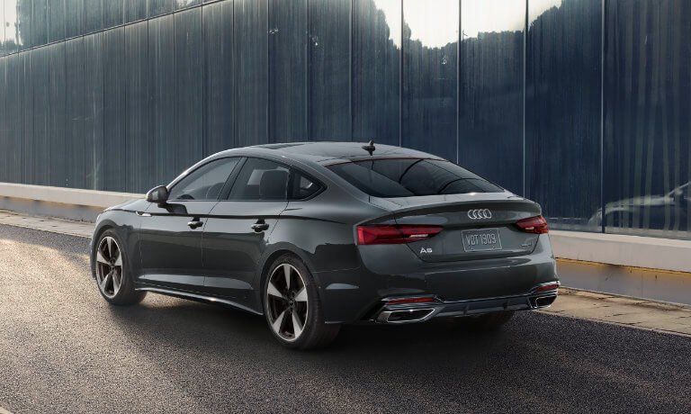2022 Audi A5 Sportback in black exterior rear view driving on the road