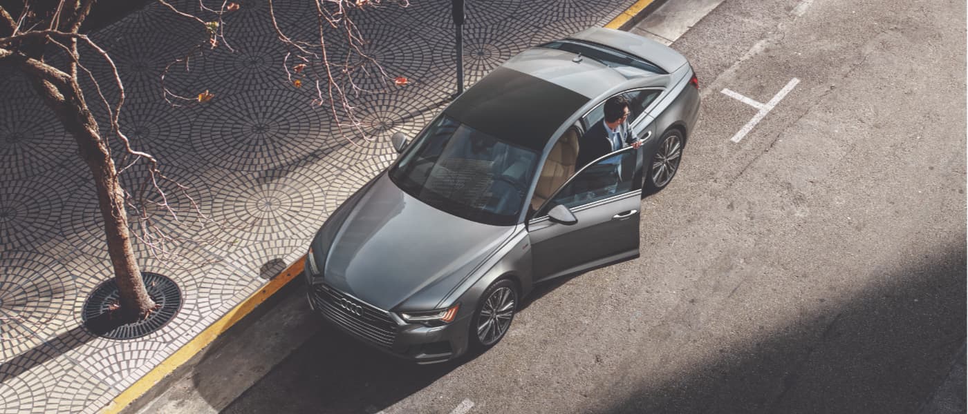 Man Getting Out of a Silver 2019 Audi A6