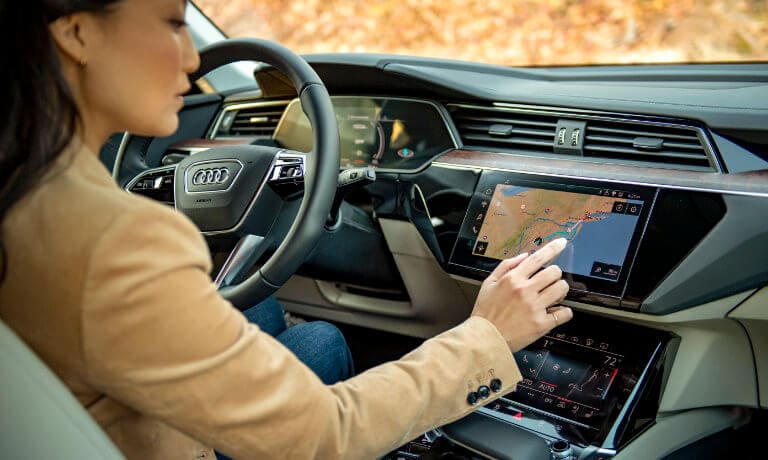 Woman looking at the 2022 Audi e-tron infotainment dashboard