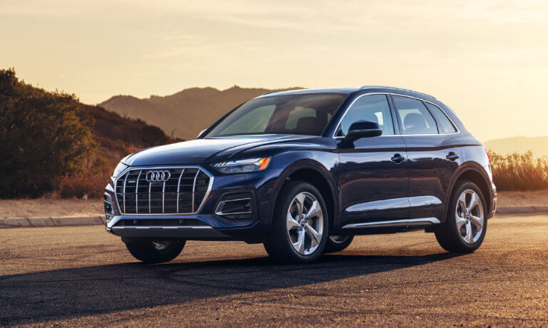 2022 Audi Q5 exterior driving through by a sunset