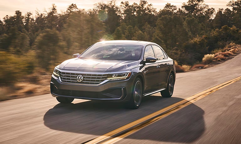 2021 Volkswagen Passat Exterior Driving On A Forest Road At Sunset