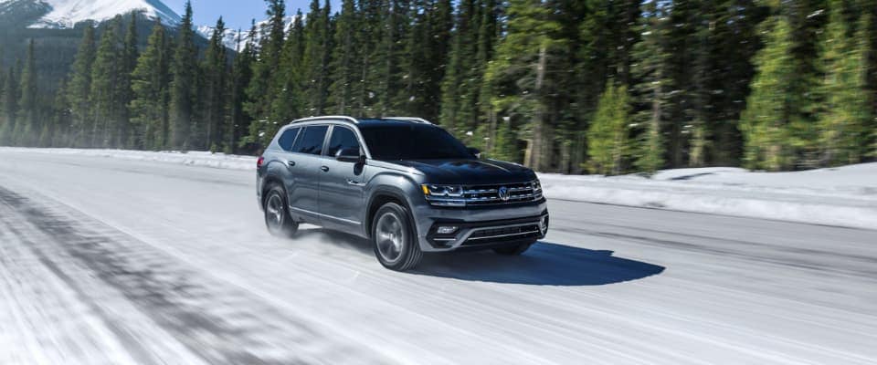 A silver 2019 Volkswagen Altas driving through the snow