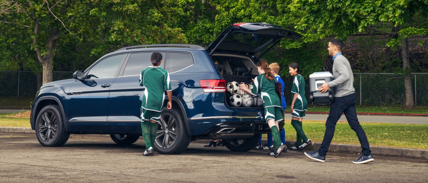 A soccer team packing their stuff in the back of their VW Atlas