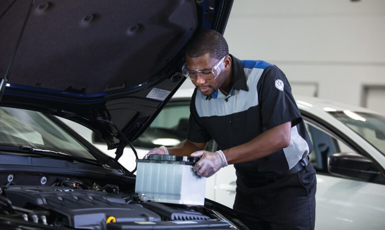 Volkswagen Tech Replacing Battery