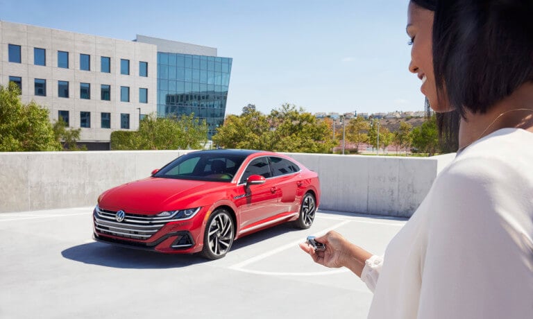 2022 VW Arteon Exterior Parked In Log With Woman Using Key Unlock