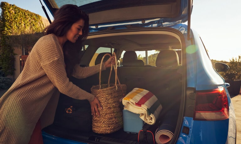 2022 Volkswagen Taos trunk storage room with woman loading items