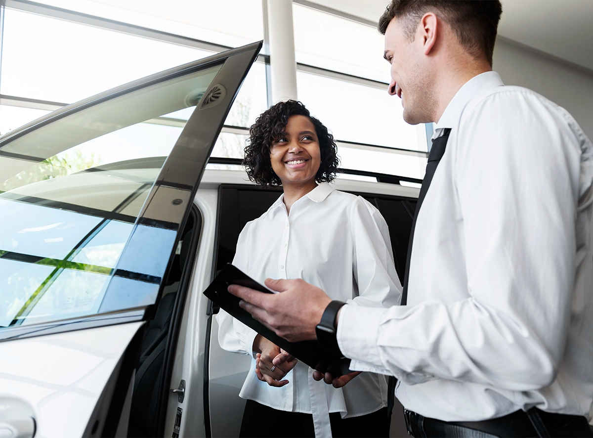 woman-enjoying-her-financially-independence-while-buying-car.webp