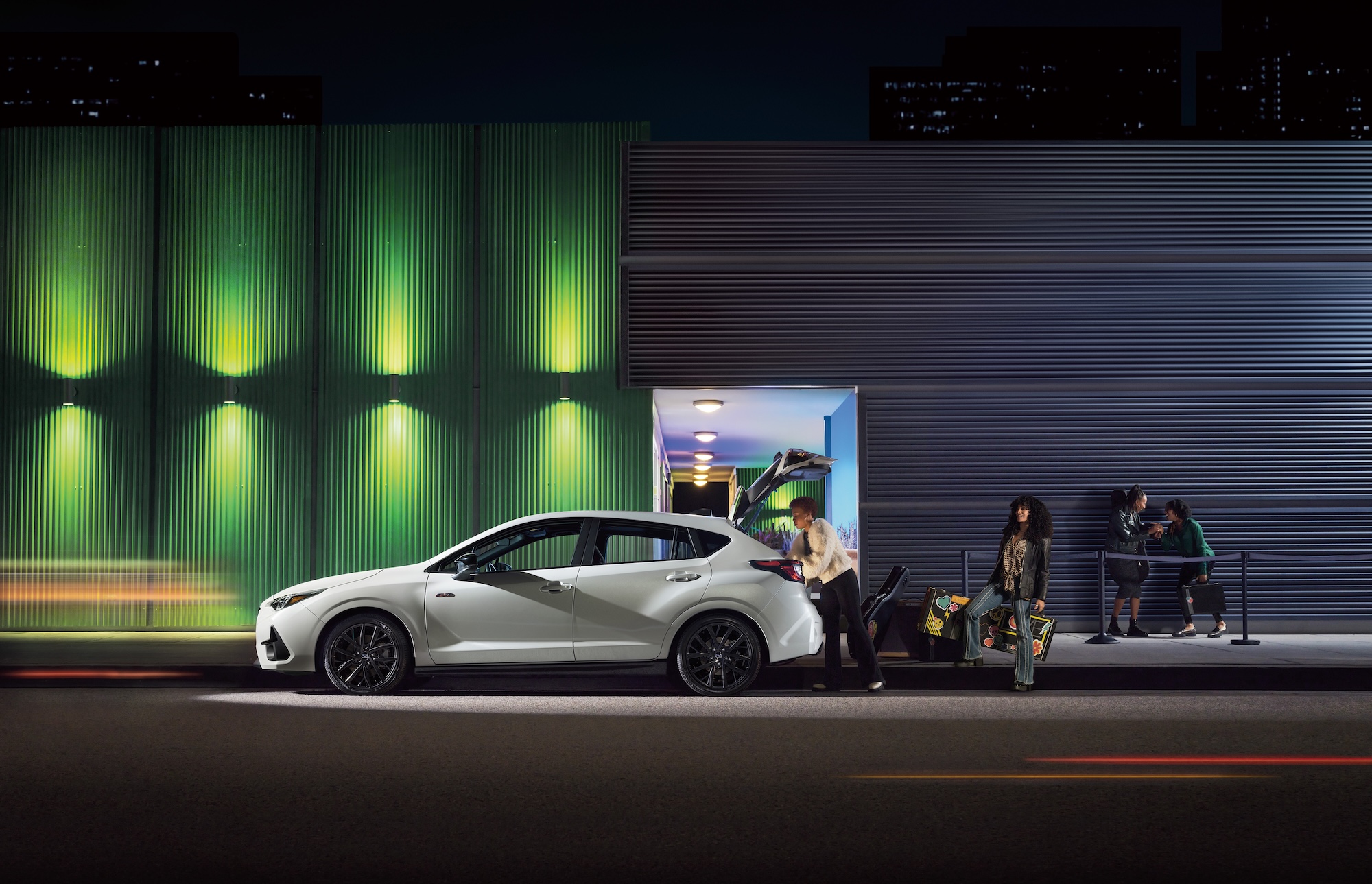 People carrying some bags into a Subaru car