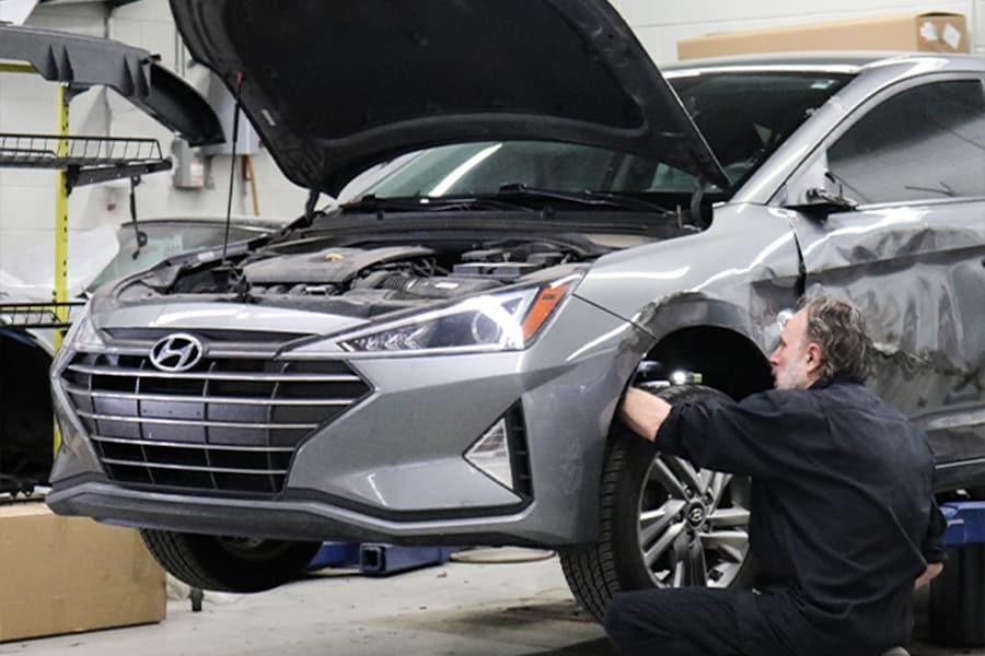 Extensive dent removal service performed on vehicle at Patrick Collision Center locations in Schaumburg and Naperville.