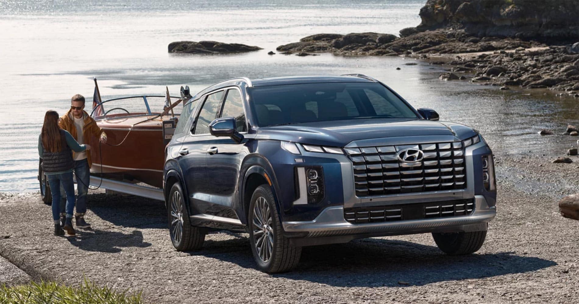 2025 Hyundai Palisade towing a boat parked at the shore