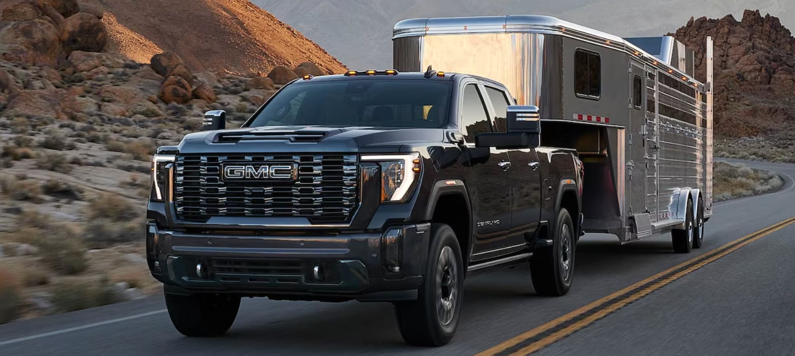 Heavy duty GMC truck hauling a trailor