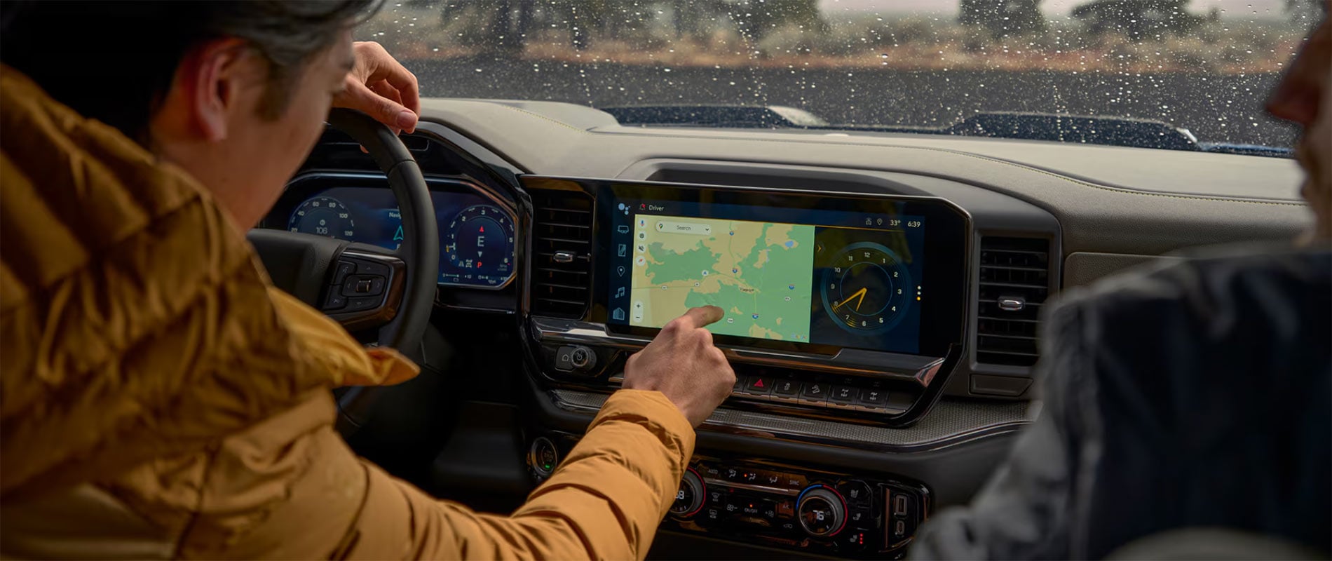 Person inside a Silverado 1500 with navigation to a Pittsburgh Dealer