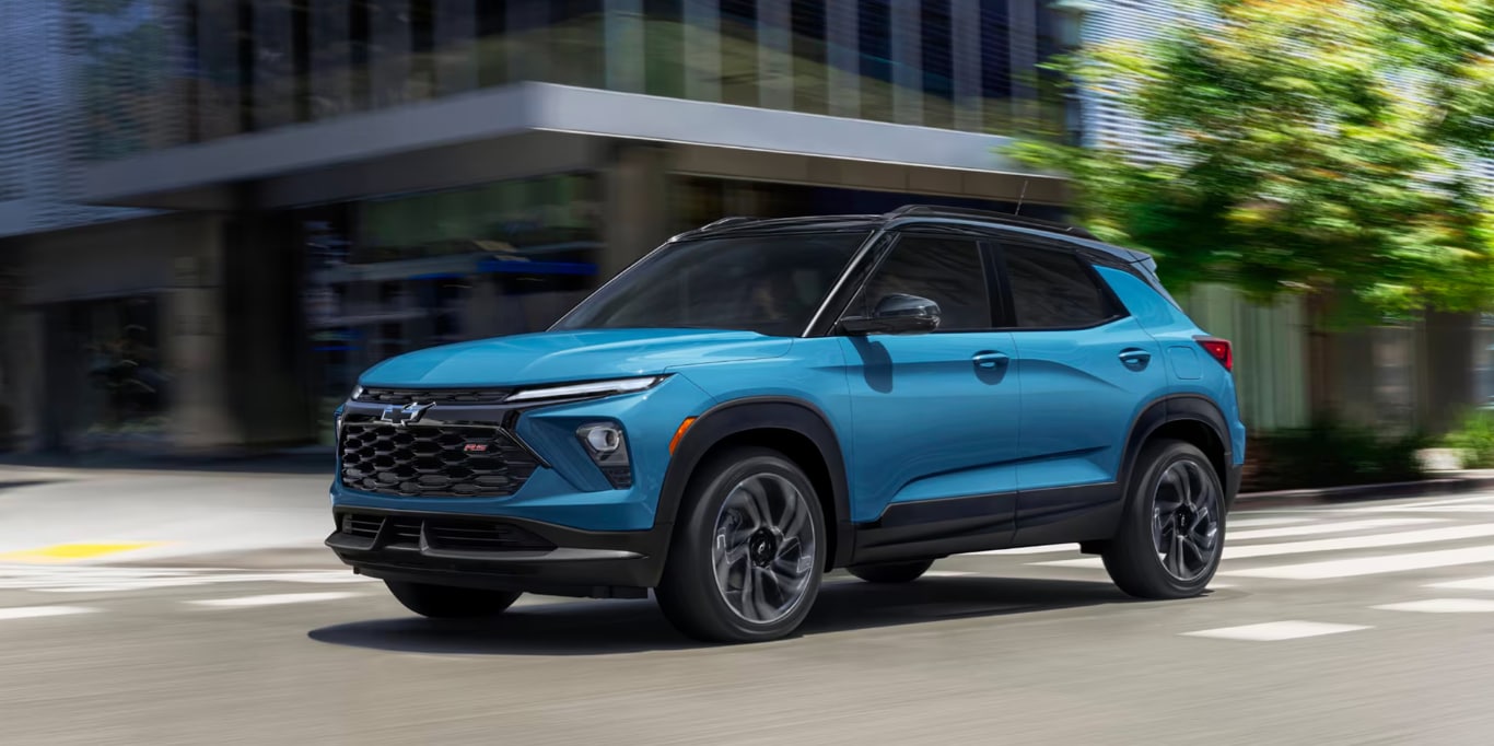 blue chevy SUV driving on the street blue chevy SUV driving on the street