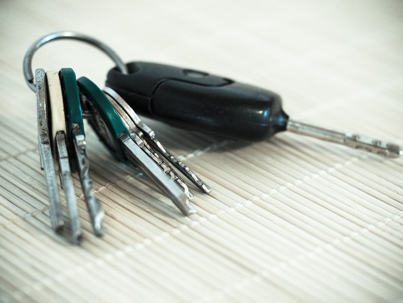 Close up of car keys on a bamboo mat