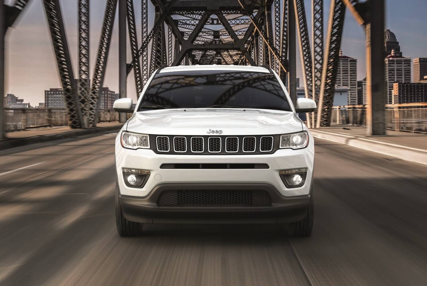 White Jeep Compass Driving on a Bridge