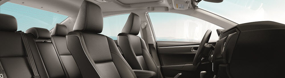 Toyota Corolla with Gray Interior. Shows 5 seats, steering wheel, and driver's side door