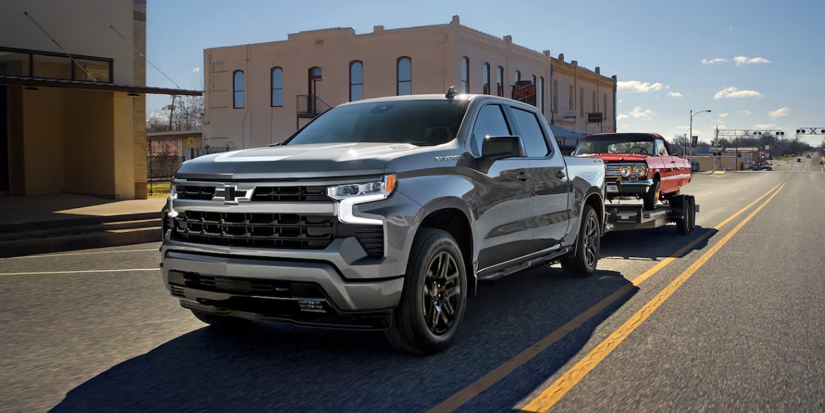 2026 Chevy Silverado towing a car