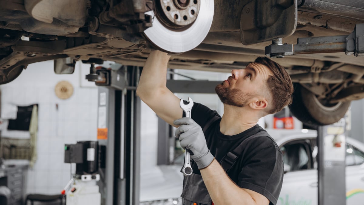 Engineer repairing brakes on vehicle