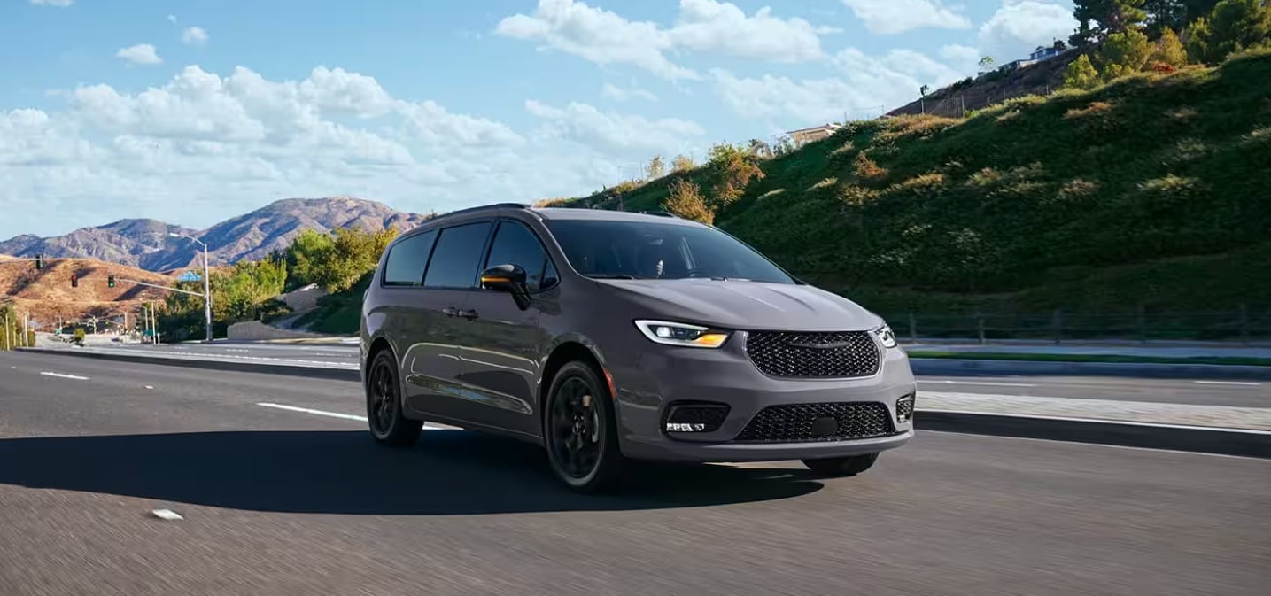 Front and side view of the 2024 Chrysler Pacifica with mountains in the background
