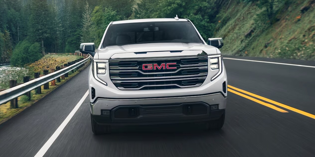 Front view of the 2024 GMC Sierra 1500 with trees in the background