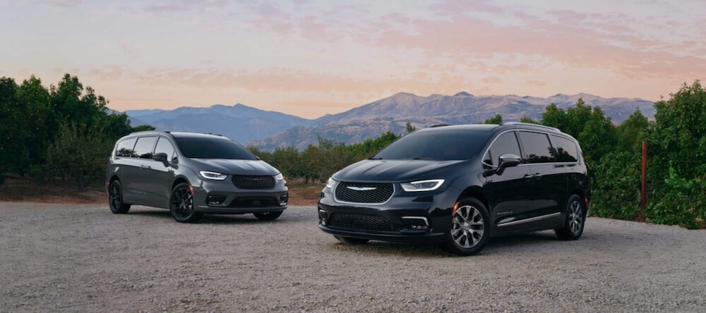 two 2023 Chrysler Pacificas parked near mountains
