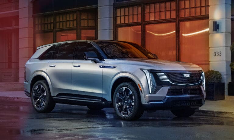 2025 Cadillac Escalade IQ on wet town street
