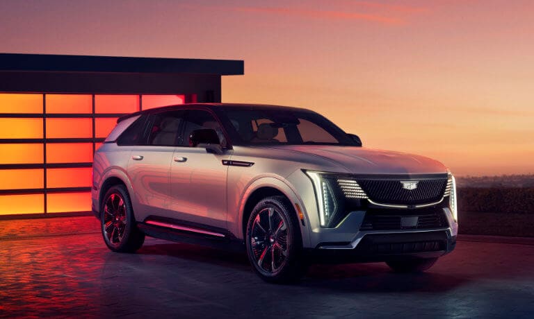 2025 Cadillac Escalade IQ parked by lit garage