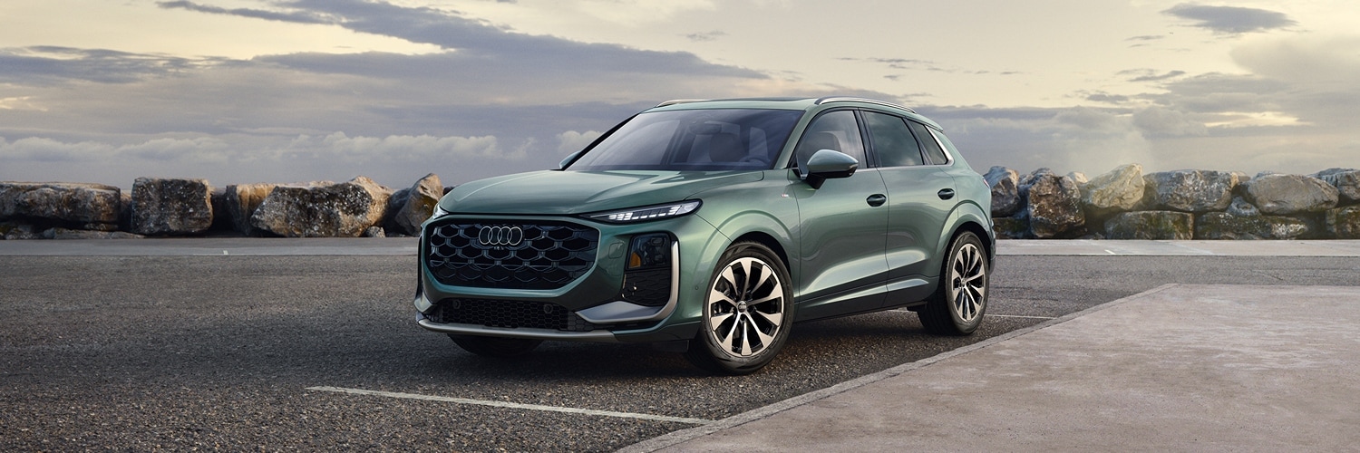 Red Audi Q3 parked by a modern house