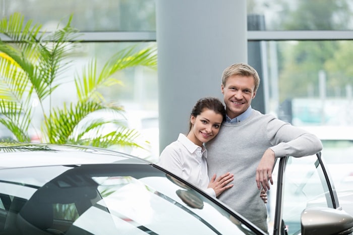 Couple_Standing_By_New_Car.jpg