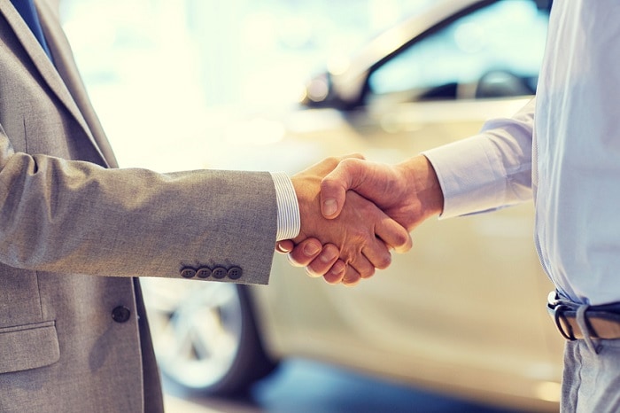 Men_Shaking_Hands_After_Car_Sale.jpg