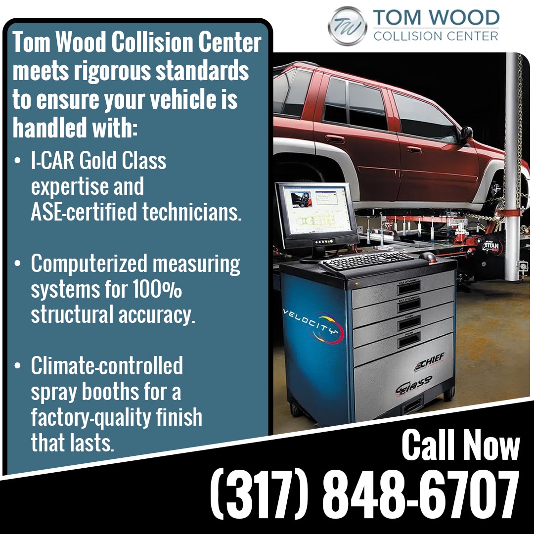 Vehicle on a computerized measuring system at Tom Wood Collision Center for precise structural collision repair