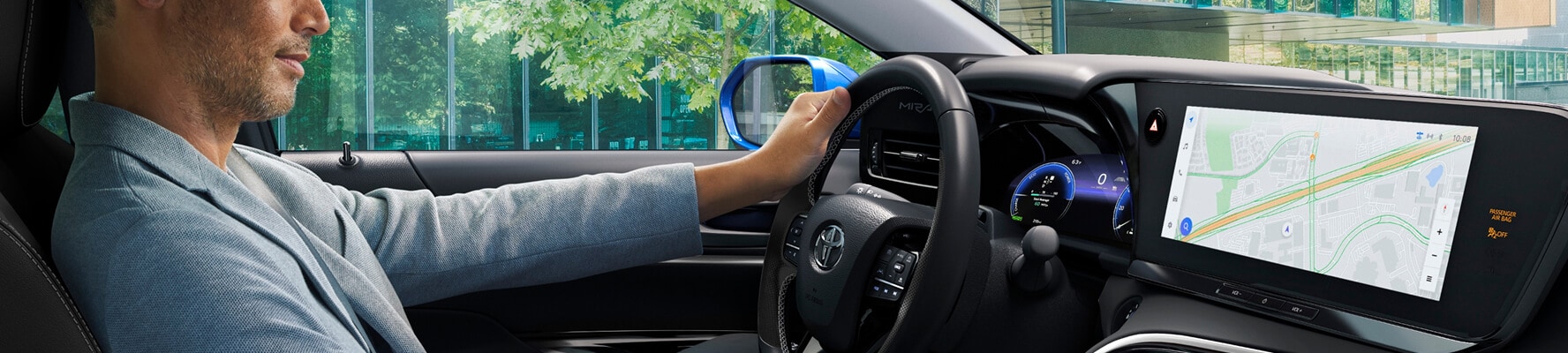 Driver using Toyota touchscreen infotainment system with digital dashboard and navigation