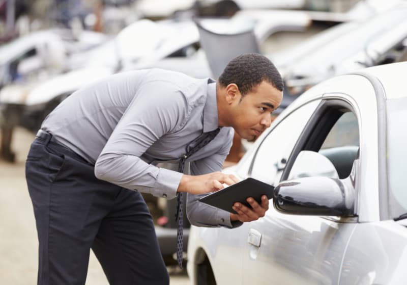 man inspecting cars