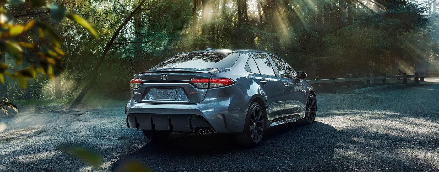 The rear of a blue 2026 Toyota Corolla rounding a corner