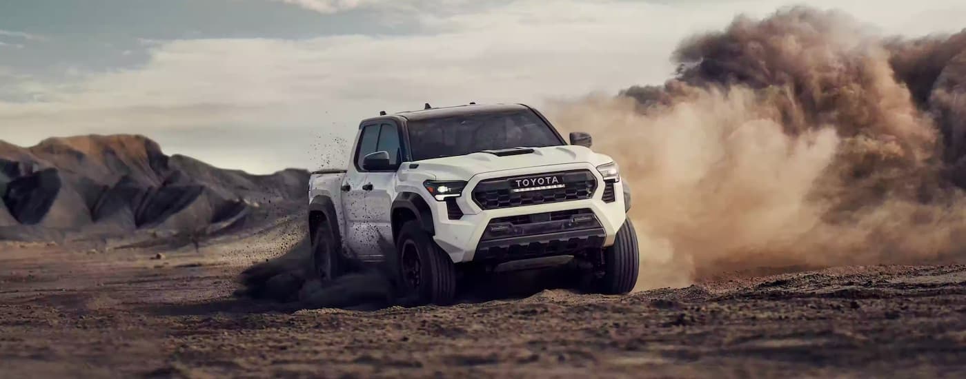 A white 2025 Toyota Tacoma from the front.