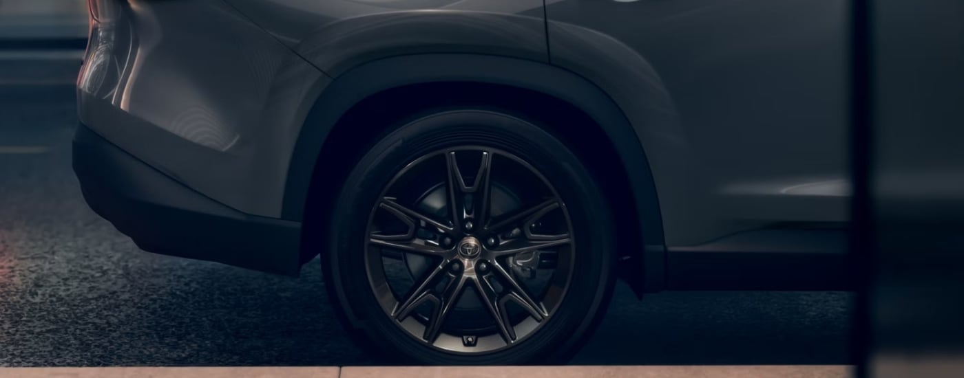 Rear passenger wheel on a grey 2025 Toyota Grand Highlander Hybrid Nightshade