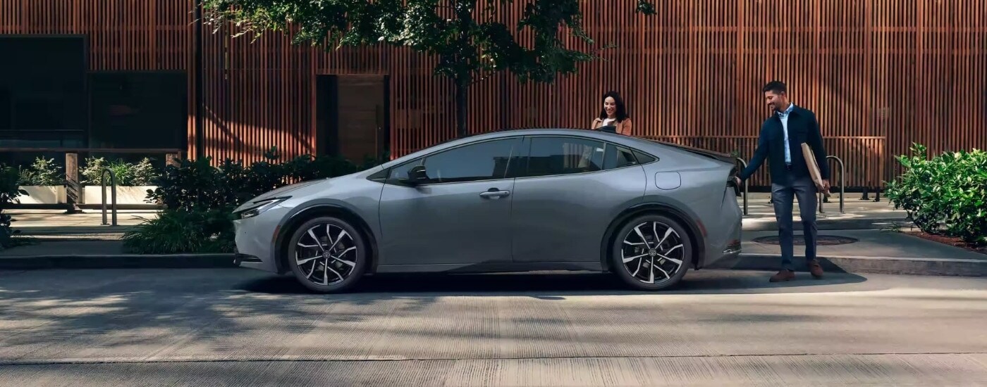 A grey 2023 Toyota Prius Prime XSE Premium parked on a city street.