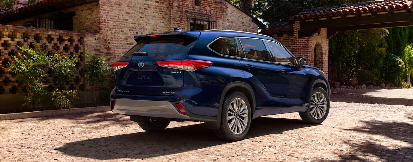 Blue 2023 Toyota Highlander Hybrid Platinum parked in a driveway
