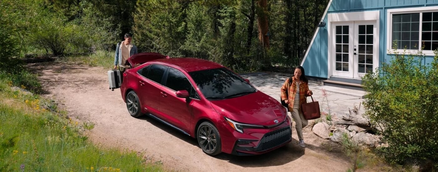 A red 2024 Toyota Corolla from the front at an angle after leaving a used car dealership near Clarksville.