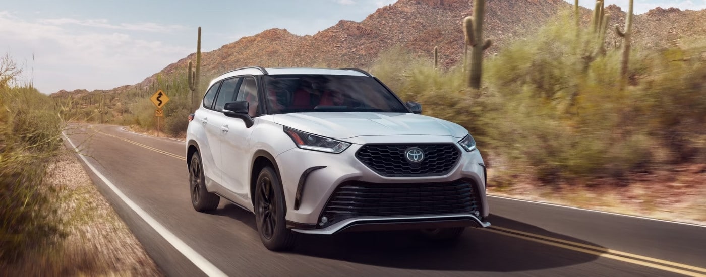 A white 2024 Toyota Highlander from the front.