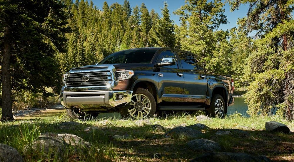 A brown 2021 Toyota Tundra parked off-road in the woods.