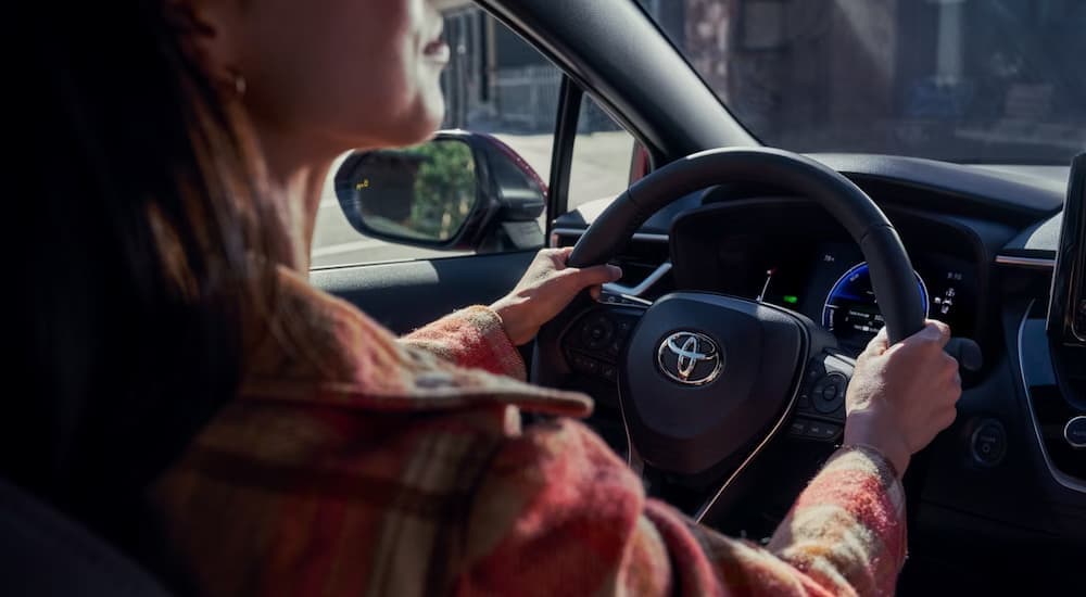 Woman driving in a 2026 Toyota Corolla
